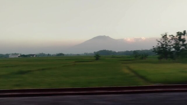 Sunset view outside the window from a moving train. traveling by train transportation