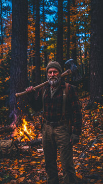Halloween woods man with axe by campfire