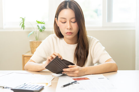 Debt financial concept, stressed problem asian woman hand open empty wallet, purse not have budget of money to pay no have credit card, not able payment bill, loan or expense with bank, bankruptcy.