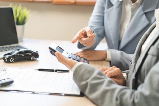 Business transport car and sell service concept, sales calculate sell price or rent of car for customer before sign on vehicle paperwork document contract with buyer woman client transfer automobile.