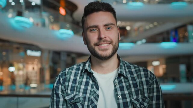 Happy Caucasian man showing welcome invitation come here gesture looking at camera in shopping mall positive business male client guy businessman demonstrate welcoming invite to join inviting indoors