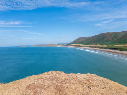Rhossilli beach and Worms head in the Gower  on a hot summer day