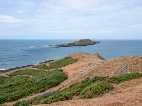 Rhossilli beach and Worms head in the Gower  on a hot summer day
