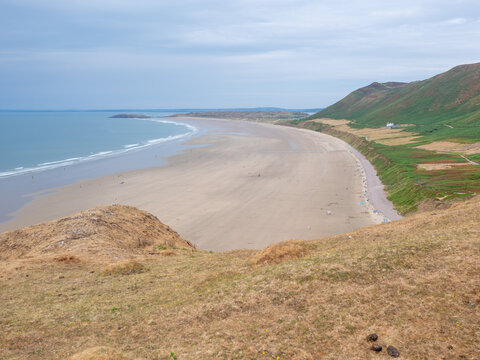 Rhossilli beach and Worms head in the Gower  on a hot summer day