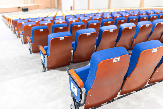 Empty Auditorium with Rows of Blue and Brown Seats