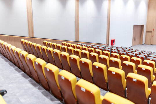Modern auditorium with comfortable seats and wooden accents