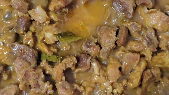 Rich, savory stew of tender meat and spices. Golden broth coats each chunk of meat. Fresh herbs float in warm, aromatic liquid. Comfort food scene, slow-cooked, deeply flavorful