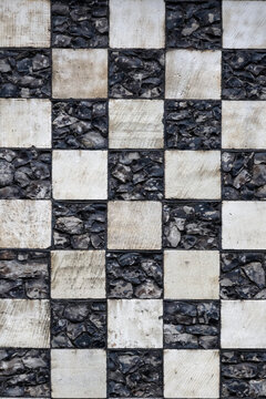 Chequerboard stone pattern on medieval church for use as a background texture