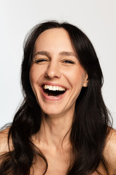 Brunette woman laughing expressing happiness and joy