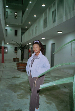 Woman wearing her braided hair up under exterior lighting