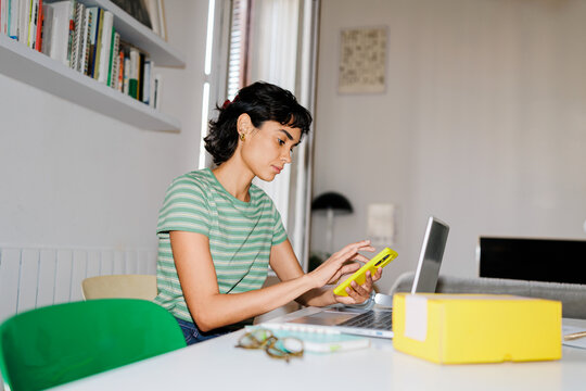 Woman checking online order tracking on phone ugc