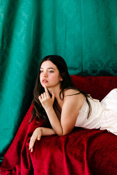 Sonia ben ammar model posing on red bed