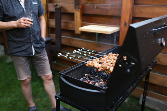 A man is preparing food on the grill.