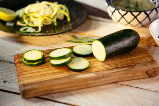 Zucchini and cucumber slices on wooden cutting board