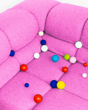 
Conceptual image of sofa full of colourful geometric balls bubbles