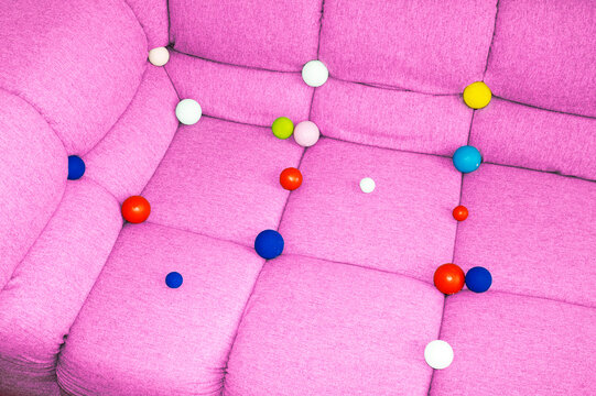 
Conceptual image of sofa full of colourful geometric balls bubbles