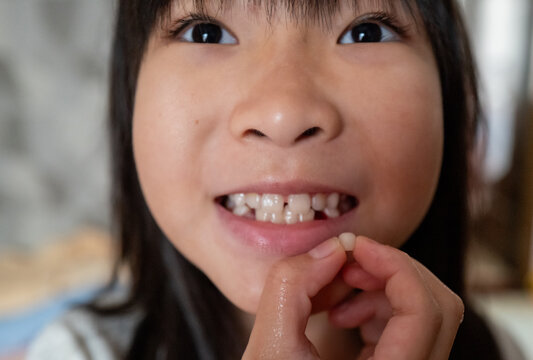 Child Shows Lost Tooth With a Big Smile at Home