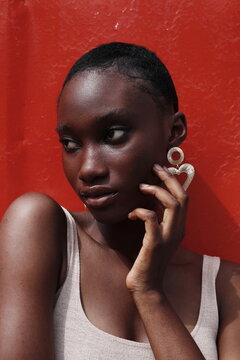 Portrait of a young lady on a outdoor red background 