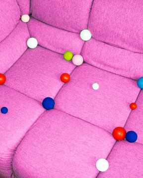 
Conceptual image of sofa full of colourful geometric balls bubbles