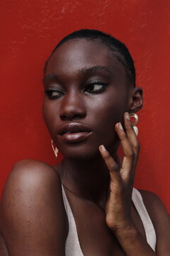 Portrait of a young lady on a outdoor red background 
