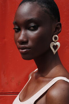 Portrait of a young lady on a outdoor red background 