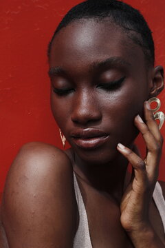 Portrait of a young lady on a outdoor red background 