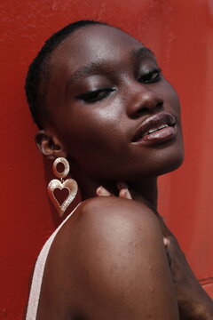 Portrait of a young lady on a outdoor red background 
