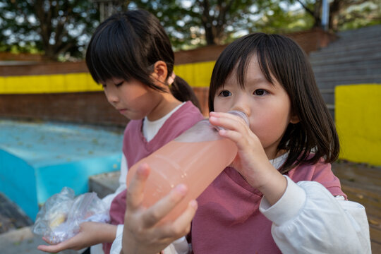 Children Drink Juice and Enjoy Snacks During Outdoor Playtime