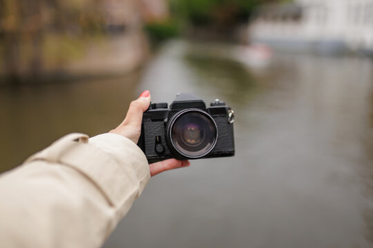 POV of Tourist Hand Holding Digital Camera Over Bruges Belgium Canal