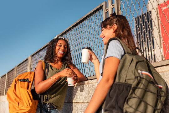 Teen girls with backpacks enjoying a sunny break