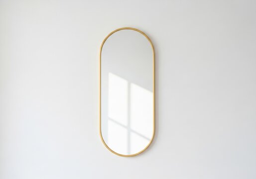 Minimalist Oval Mirror Reflection: A sleek, oval-shaped mirror with a thin golden frame hangs on a clean white wall, catching the soft, geometric patterns of sunlight and shadow.