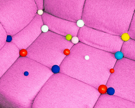 
Conceptual image of sofa full of colourful geometric balls bubbles
