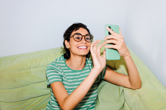 Woman laughing enjoying video call at home ugc