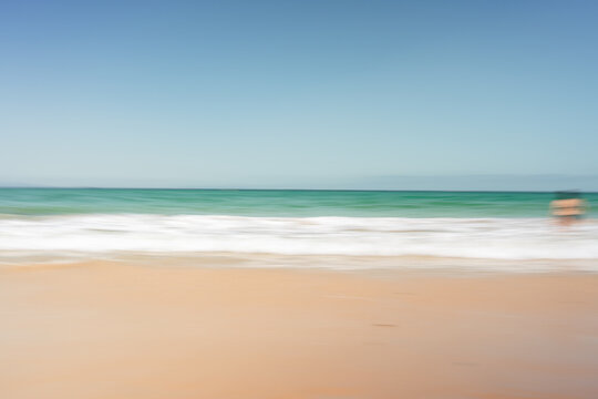 Blue ocean waves washing sand beach shore