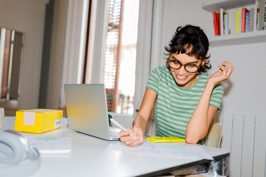 Woman taking notes at apartment ugc