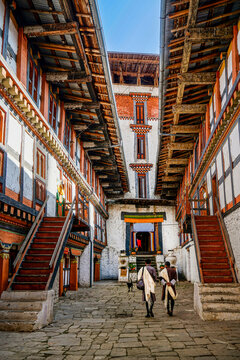 Bhoutan,  men entering the Jakar Dzong (monastery) in tradition clothes.