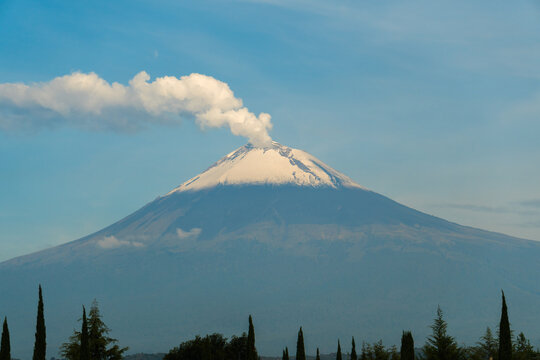 Popocatepetl volcano erupting steam and ash at sunrise in mexico