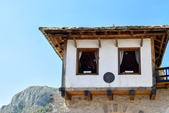Traditional Wooden Bay Window Structure Over Stone Arch