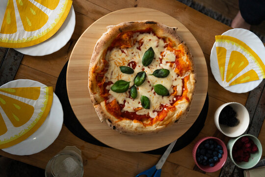 Homemade Margherita Pizza Shared at Dining Table