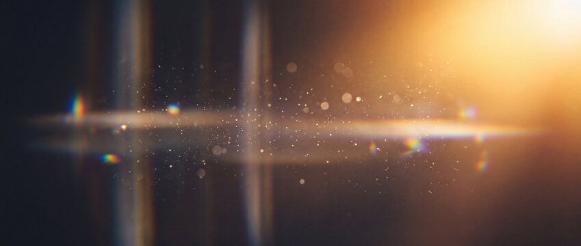 Lens flare with golden dust particles and anamorphic rainbow prism light streaks on a dark background, creating a cinematic lighting overlay for video editing and photography