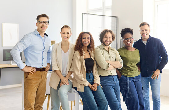 Team business office colleagues portrait group diversity smiling. Bright workspace underscores teamwork for corporate websites, people and employer branding. Clear theme of strong team spirit.
