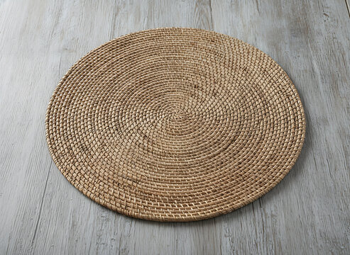 Round Woven Rattan Placemat On Light Gray Wood Table For Natural