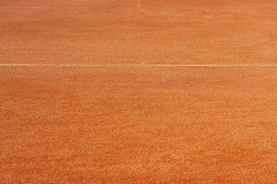  A yellow tennis ground court grande arena.  Free textured tennis clay court in sunlight, ready to play.