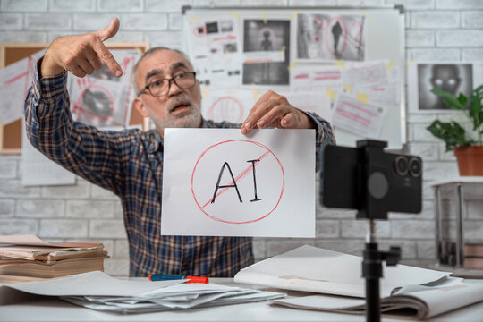 Senior conspiracy blogger pointing at a crossed out AI sign while recording an emotional video on a smartphone