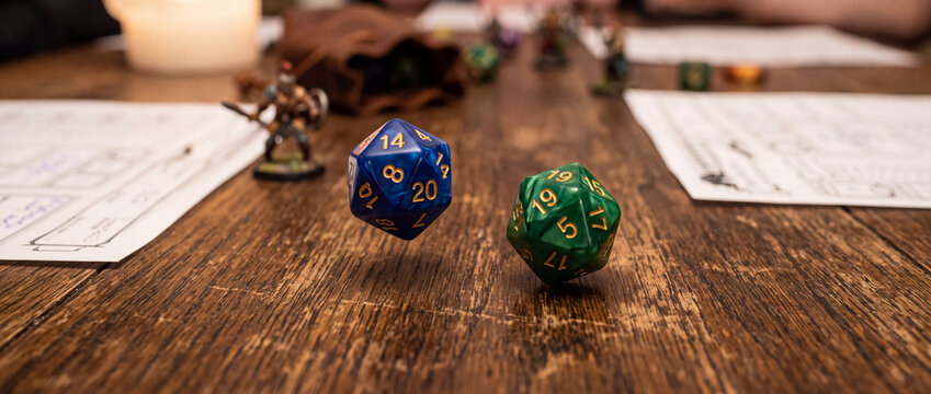 Tabletop roleplaying game night with colorful d20 dice rolling over wooden table with miniatures