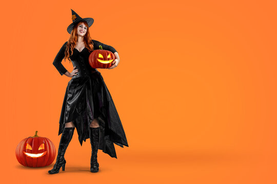 Witch on Halloween. Female wizard fairy character for All Saints' Day. Fantasy gothic red-haired Vampire girl in black dress. Enchantress dressed in carnival costume
