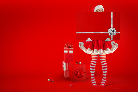 Christmas Santa Helper Elf female character. Women wearing Fancy red Dress and hat. Ladies Xmas Party Outfit