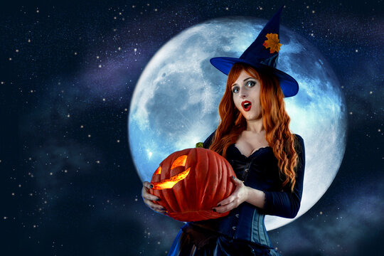 Witch on Halloween. Female wizard fairy character for All Saints' Day. Fantasy gothic red-haired Vampire girl in black dress. Enchantress dressed in carnival costume