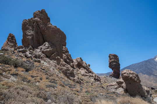Rock formations of Roques de Garc&iacute;a in Teide National Park, Tenerife, Spain, rising above a dry volcanic landscape under a clear blue sky