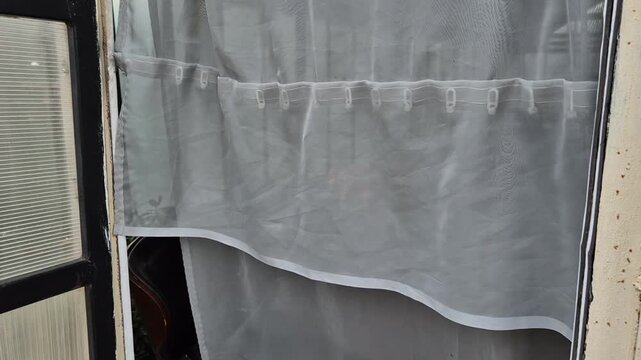 Close-up shot of a fabric insect screen curtain hanging over a doorway